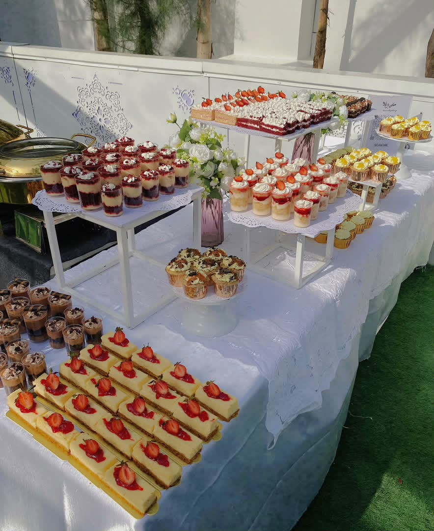 Dessert table with cheesecakes, cupcakes and dessert cups