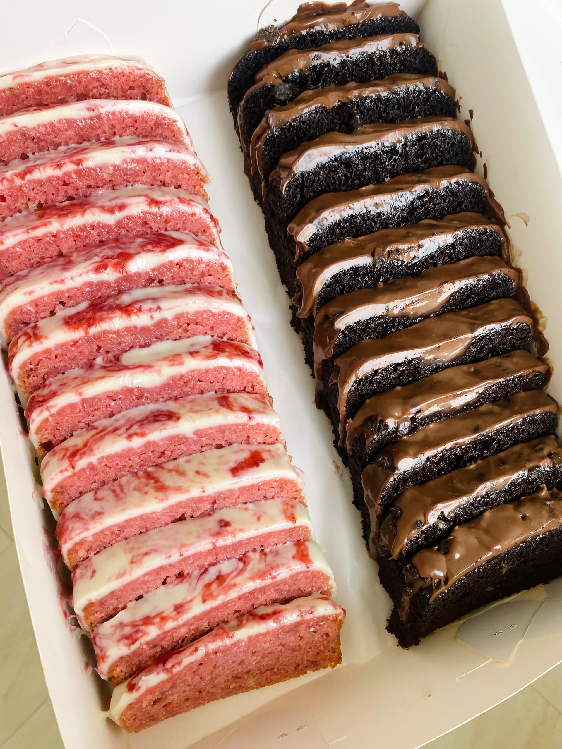 Trays of pink strawberry and chocolate cake slices